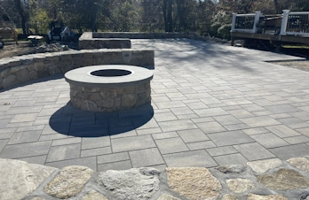 Lexington, Massachusetts - Community asphalt circle with curbs and brick pavers.