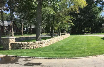 Beautiful stacked stone curved wall in Wellesley, Massachusetts