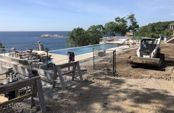 Leveling yard next to infinity pool in Gloucester, Massachusetts