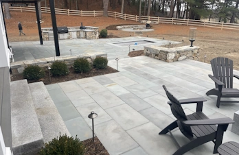 Outdoor area featuring a lap pool, kitchen, and firepit in Concord, Massachusetts